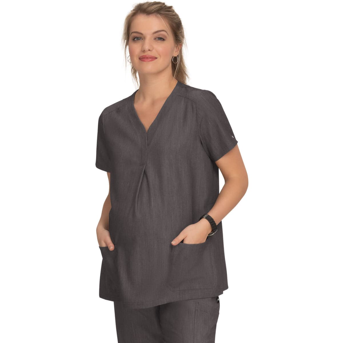 A dark grey maternity top with a V-neck and short sleeves, featuring two front pockets. A logo is visible.