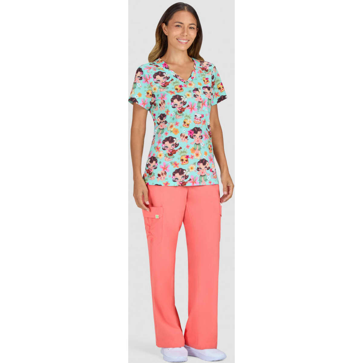A floral print top in blue, paired with coral pants, worn by a model standing against a neutral background.