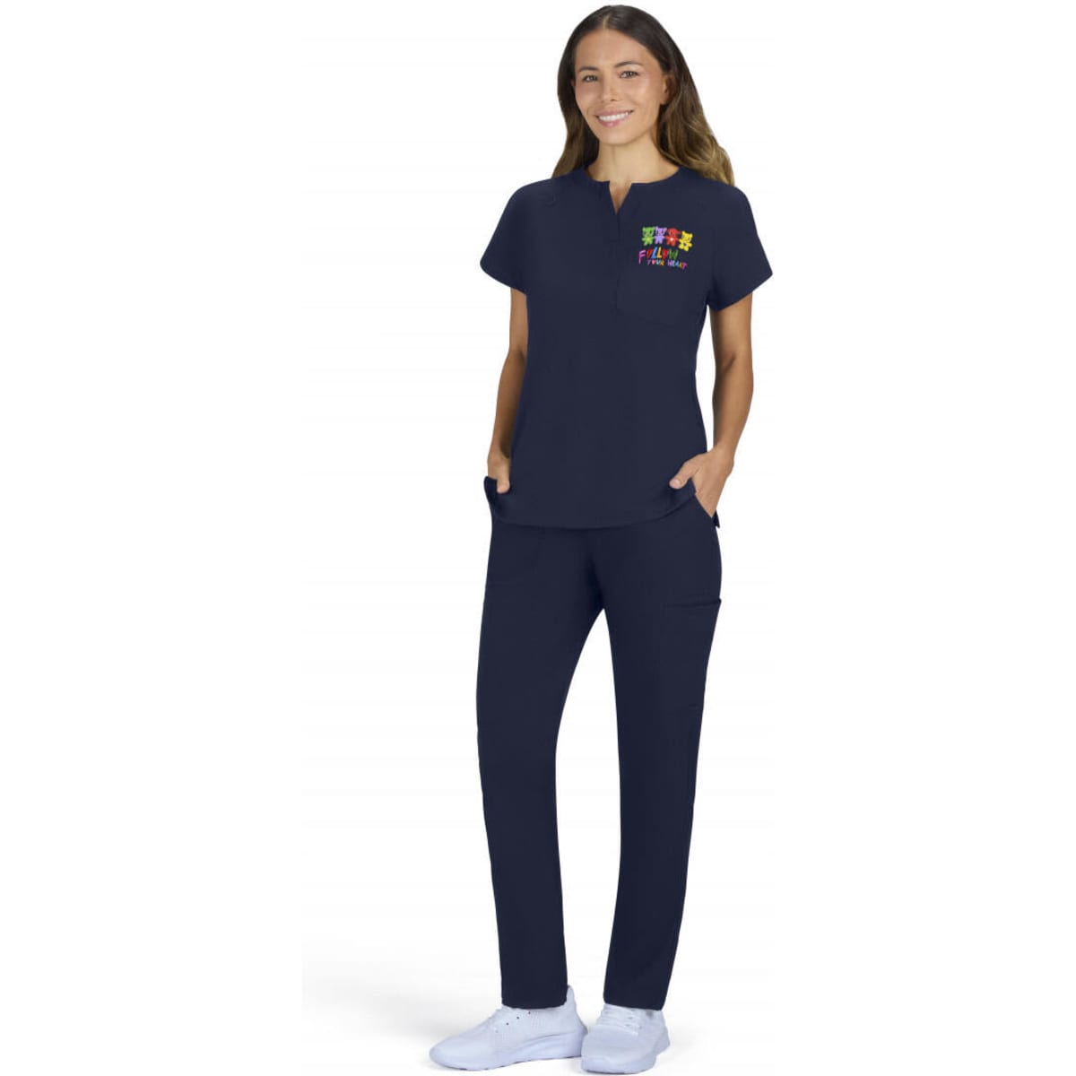 A woman wearing a navy placement top and matching pants, with pockets and a colourful logo on the top.