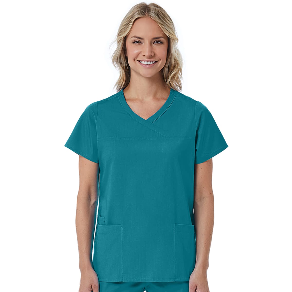 A teal women's mock wrap top featuring short sleeves and two front pockets. The model stands smiling.