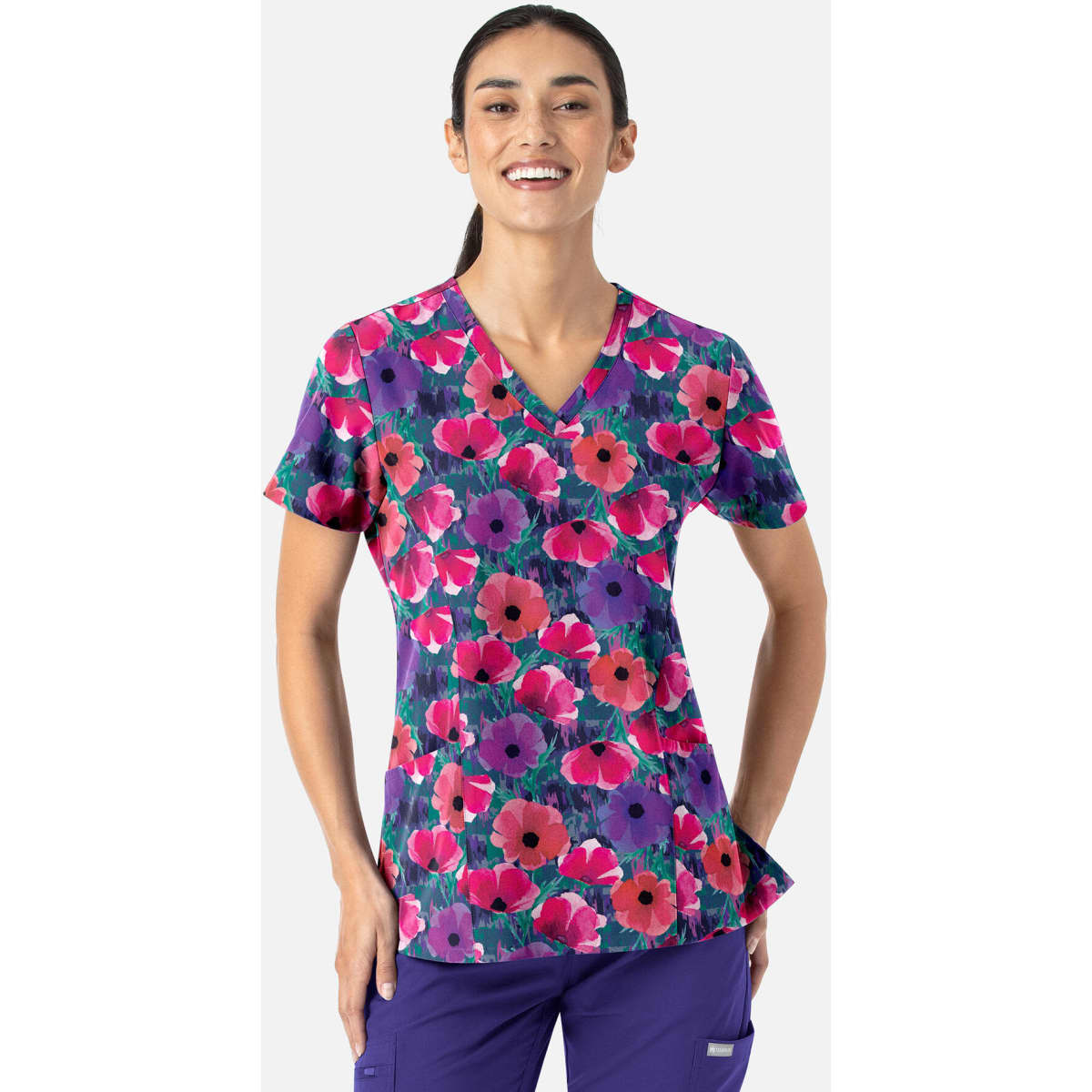 A vibrant women's V-neck top featuring a floral print in purple, pink, and green hues. It includes a logo.