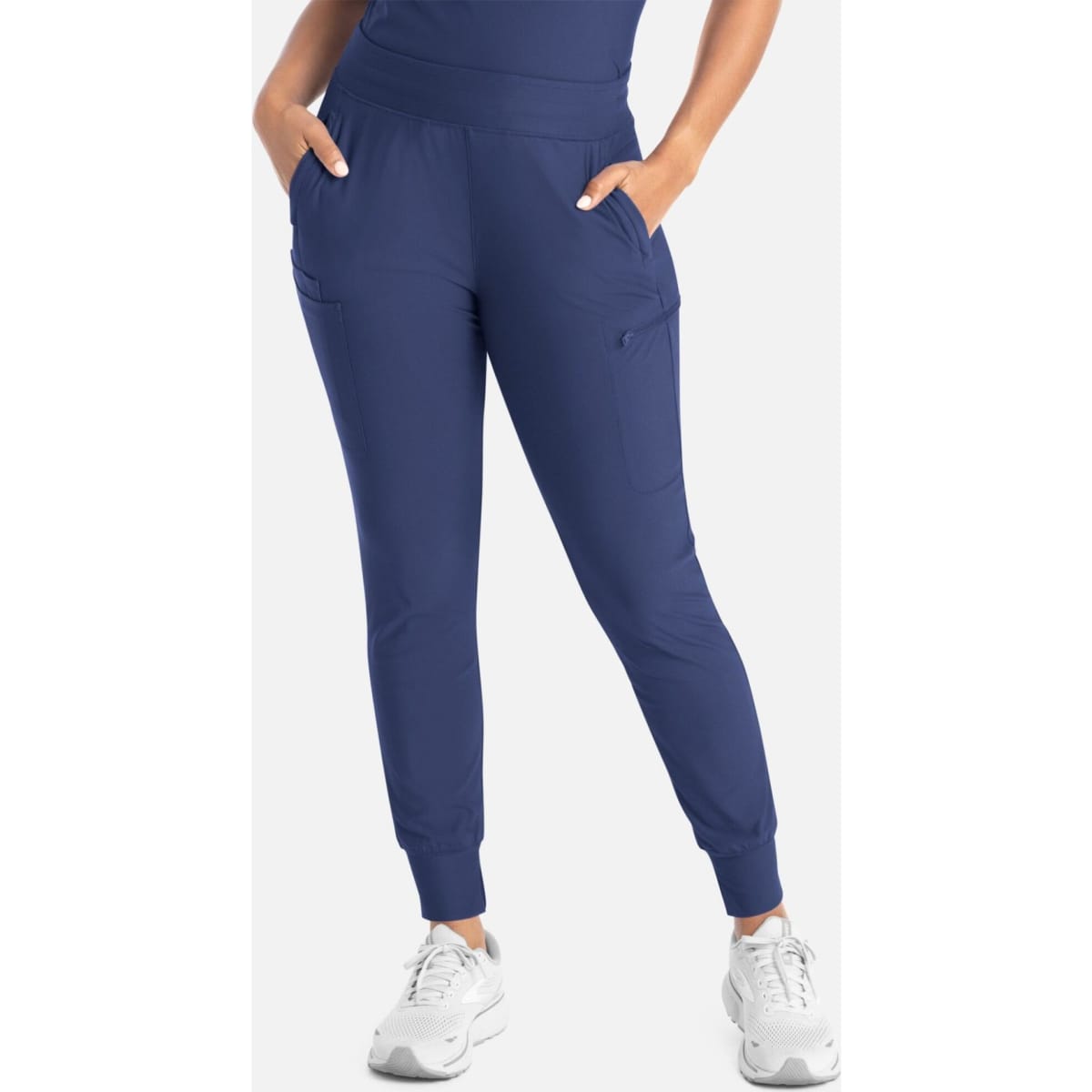 A pair of navy mid-rise joggers with pockets and elastic cuffs, accompanied by a person wearing them.