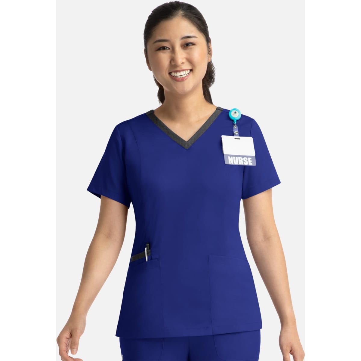 A woman's blue double V-neck top with contrasting neckline, featuring a pocket and a name badge holder.