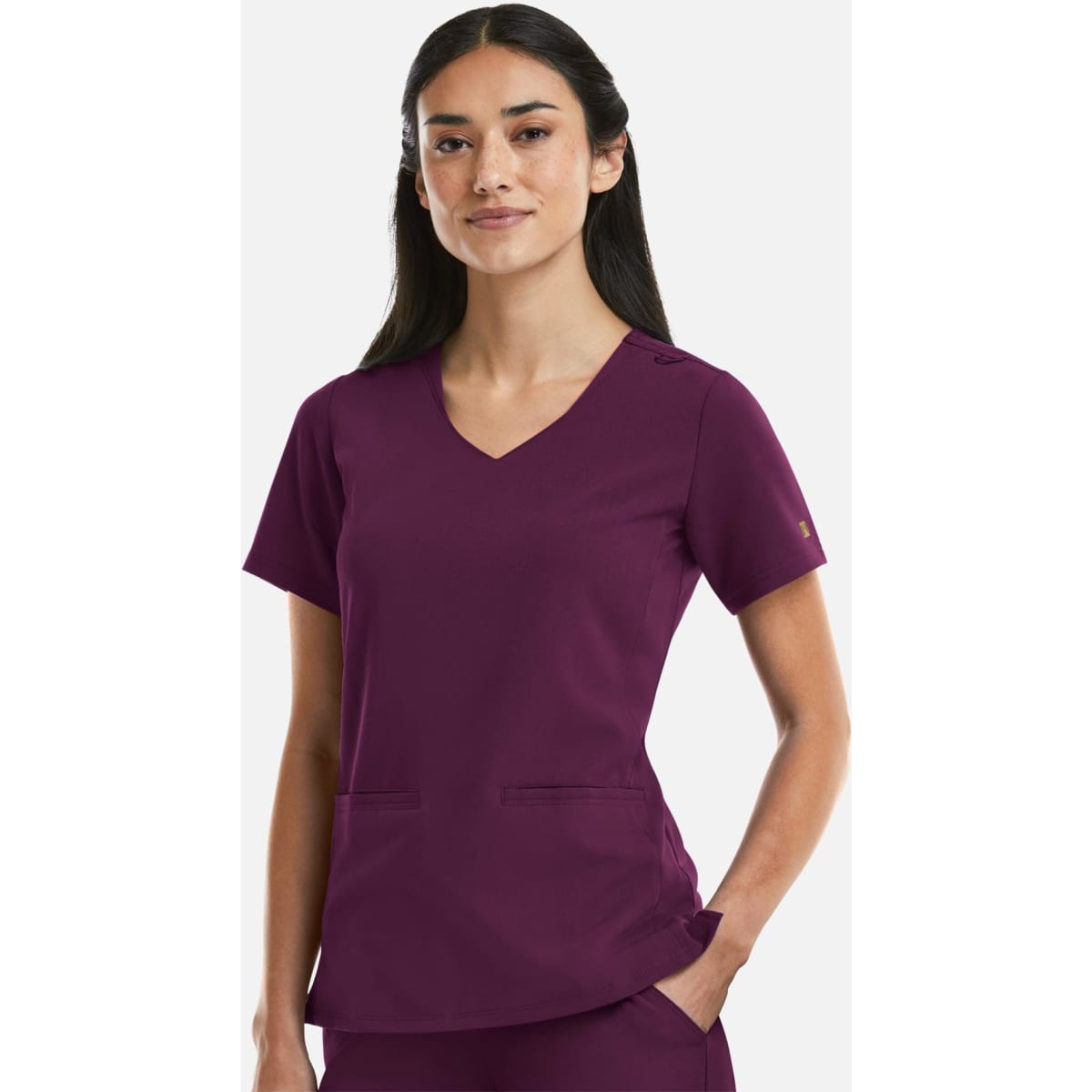 A women's curved V-neck top in a deep purple colour, featuring a logo, with short sleeves and front pockets.