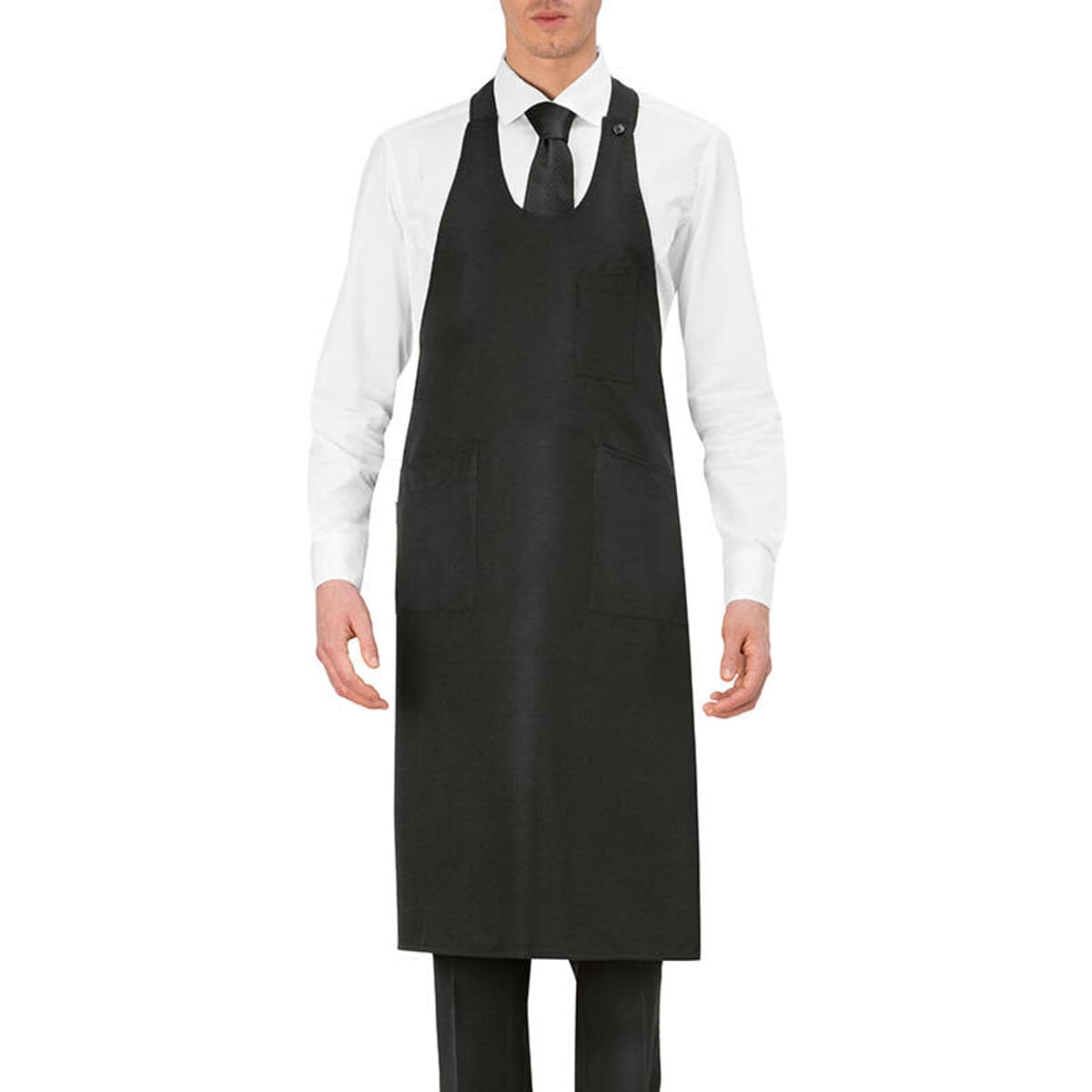 A black apron with a neck loop, featuring two front pockets, worn by a model in a white shirt and tie.