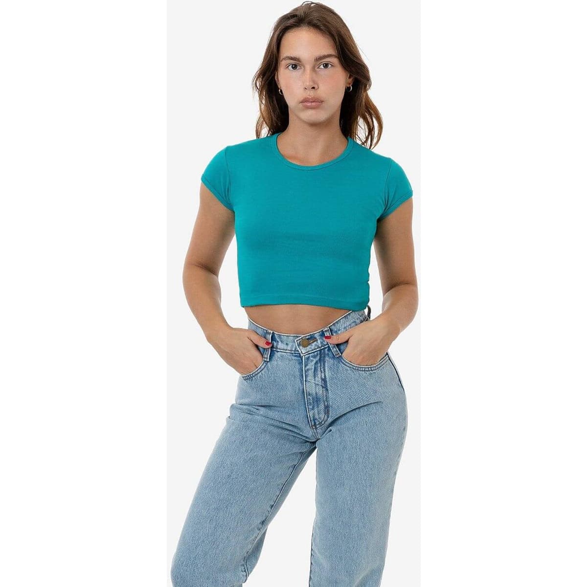 A fitted turquoise cap sleeve crop top displayed on a model, paired with high-waisted blue jeans.