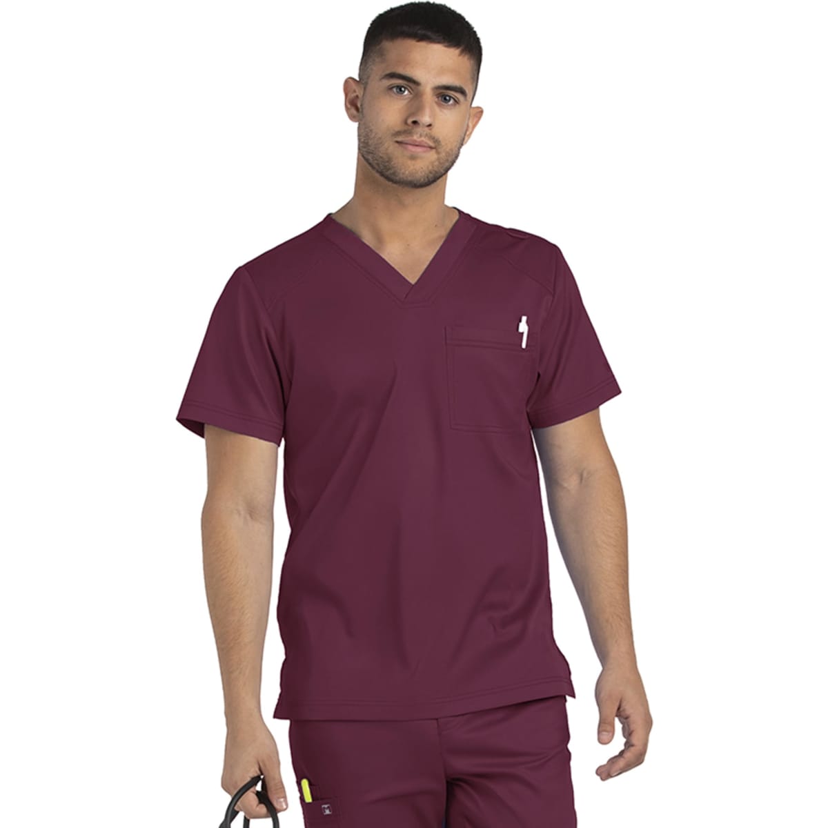 A man wears a maroon men's tuckable V-neck top with a chest pocket and holds a pair of scissors.