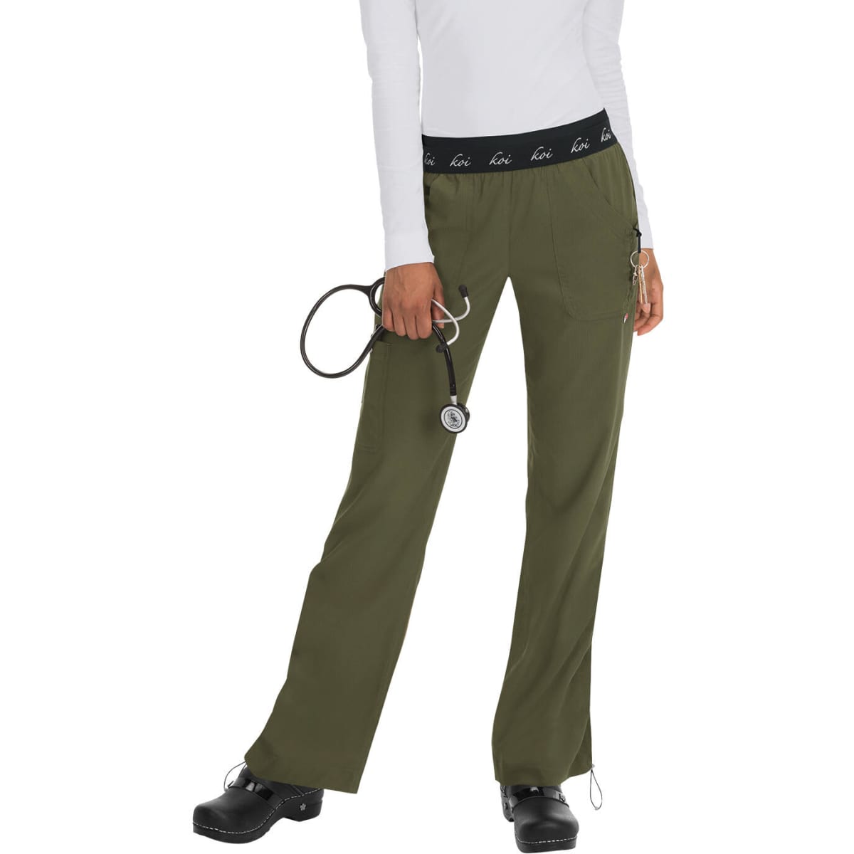 A pair of olive green scrubs with a black waistband, featuring a logo, held by a person with a stethoscope.