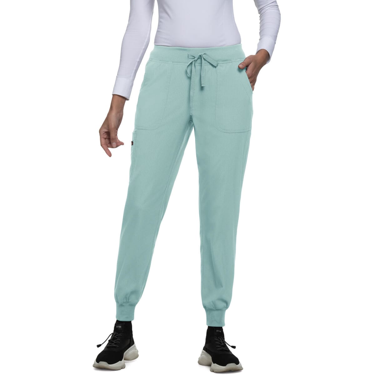 A pair of mint green joggers with a drawstring waist and side pockets, styled with a fitted white top.