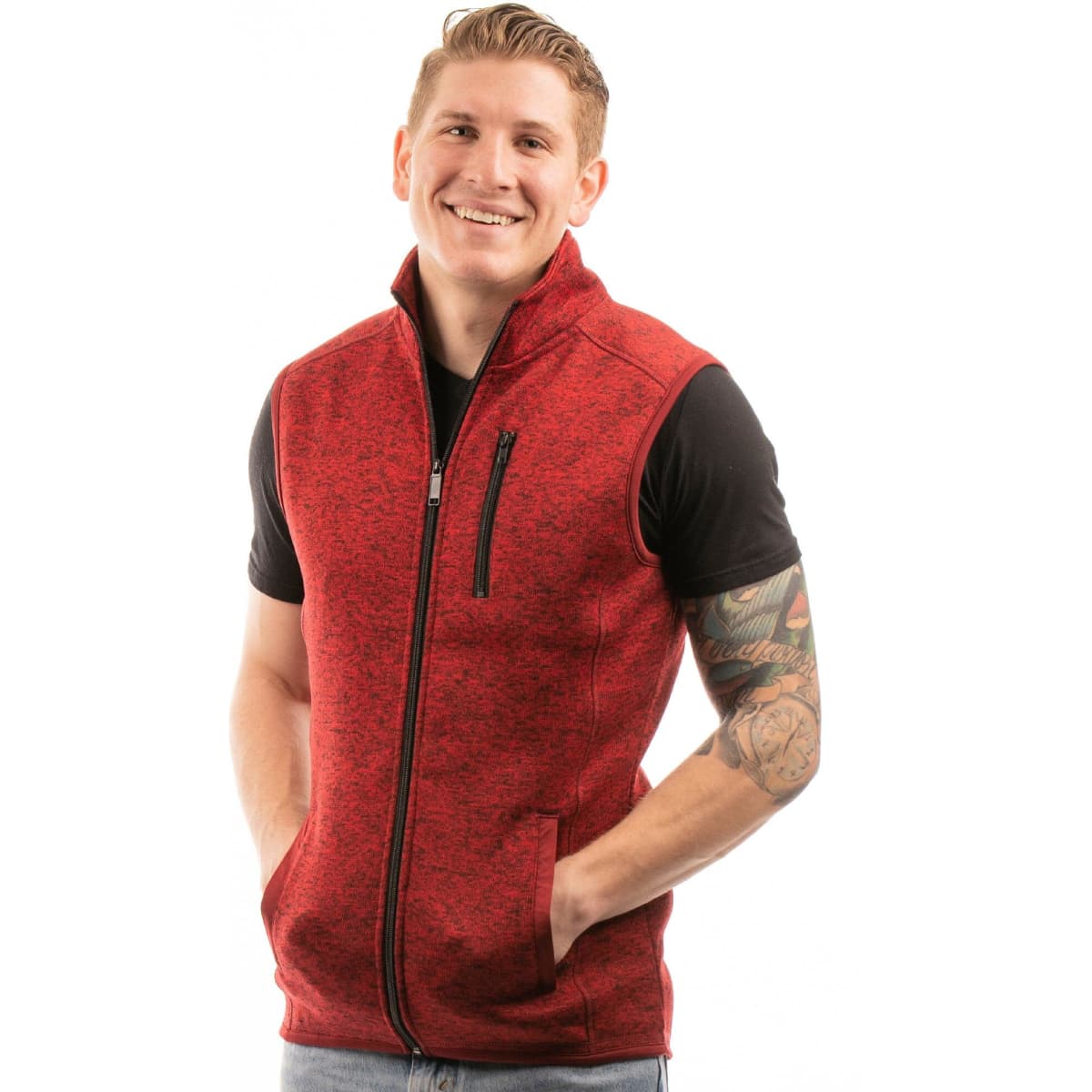 A red sweater knit vest with a full zip and pockets, worn over a black T-shirt by a smiling model.