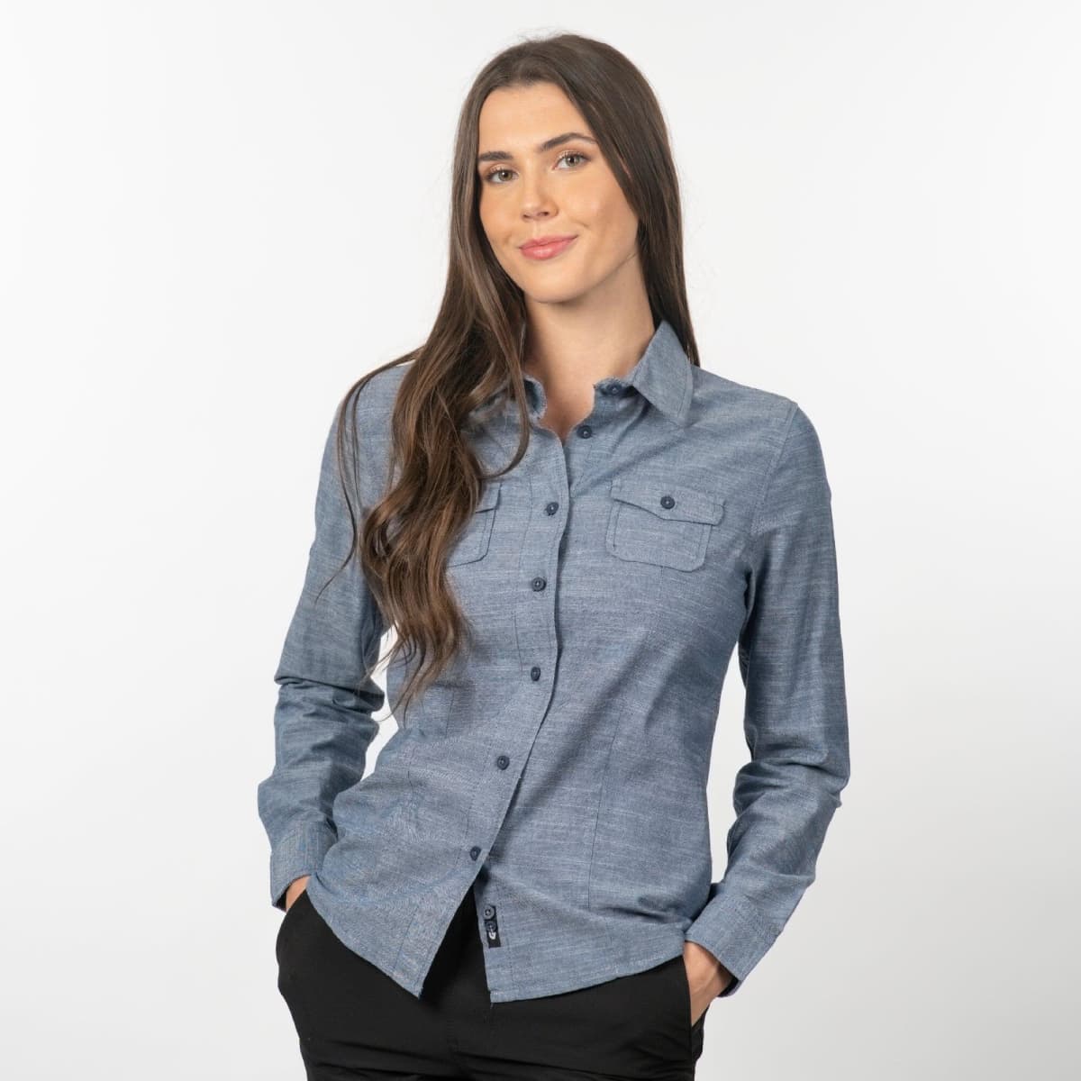 A long sleeve chambray button-up shirt in blue, featuring a chest pocket and a logo.