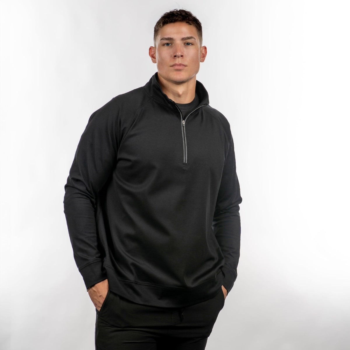 A black quarter-zip windbreaker featuring a stand-up collar and long sleeves, shown on a model against a light background.