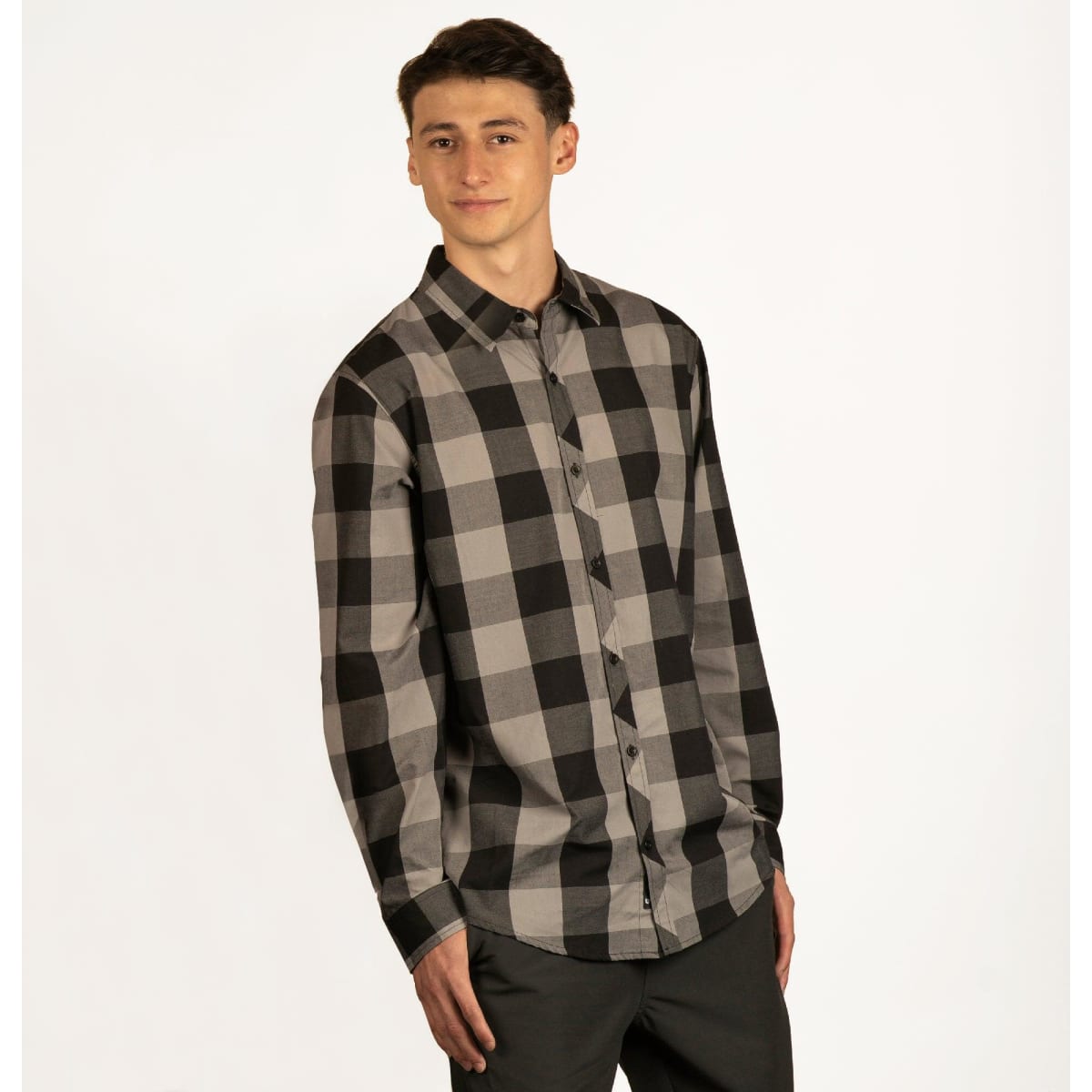 A long-sleeve, button-up shirt featuring a black and grey plaid pattern, with a logo on the chest.