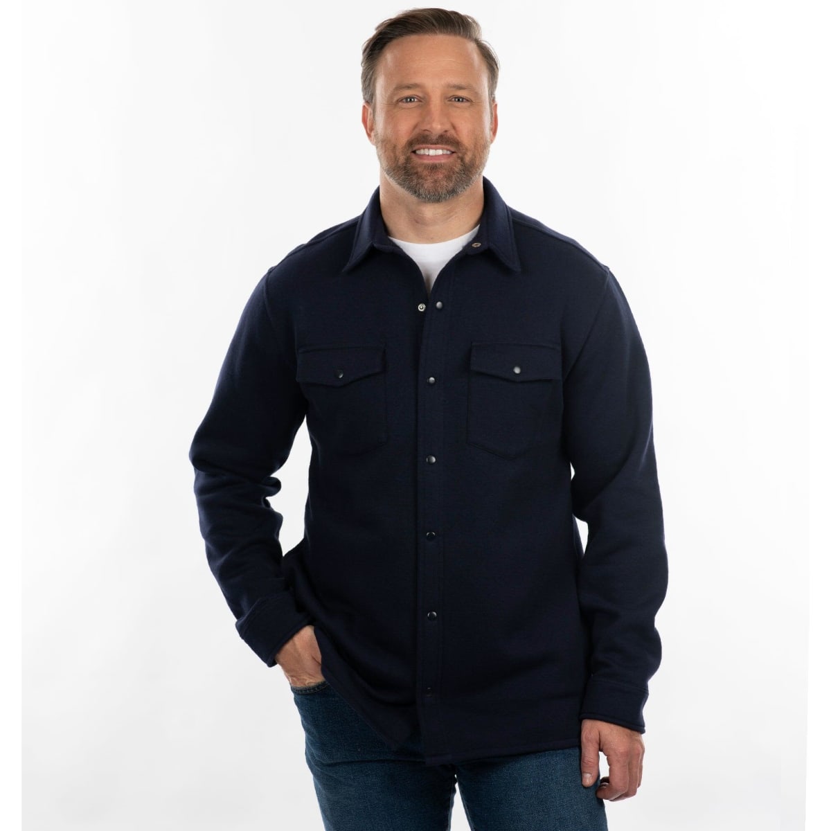 A man smiling while wearing a navy fleece snap jacket with two chest pockets. The background is plain white.