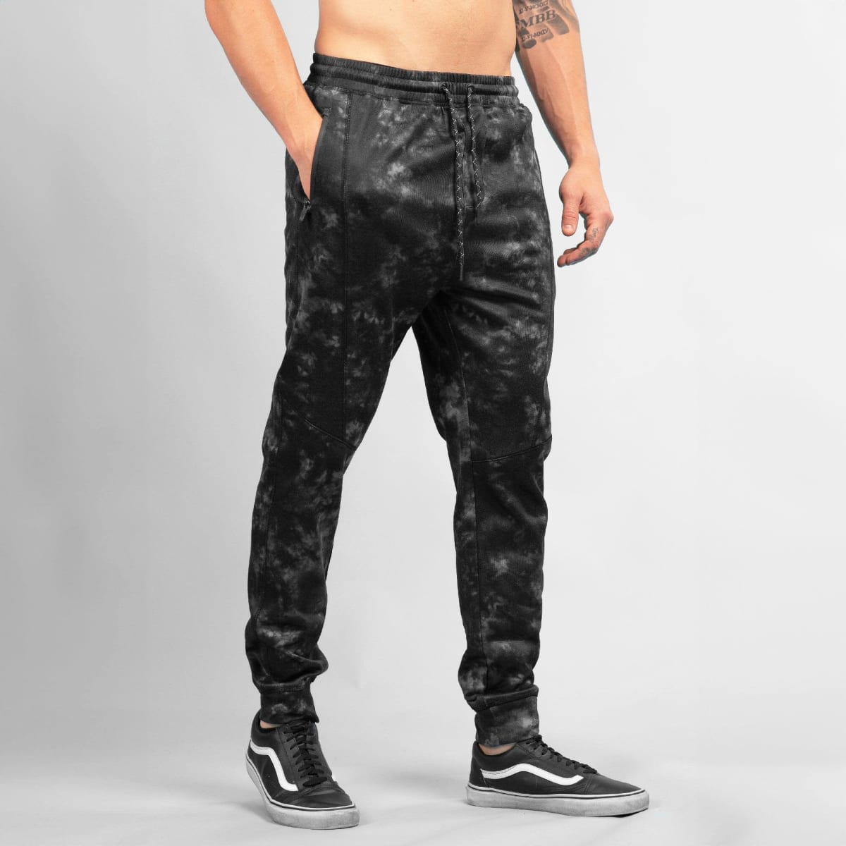 Black Tech Fleece Knit Jogger Pants with a textured design and side pockets, featuring a logo.