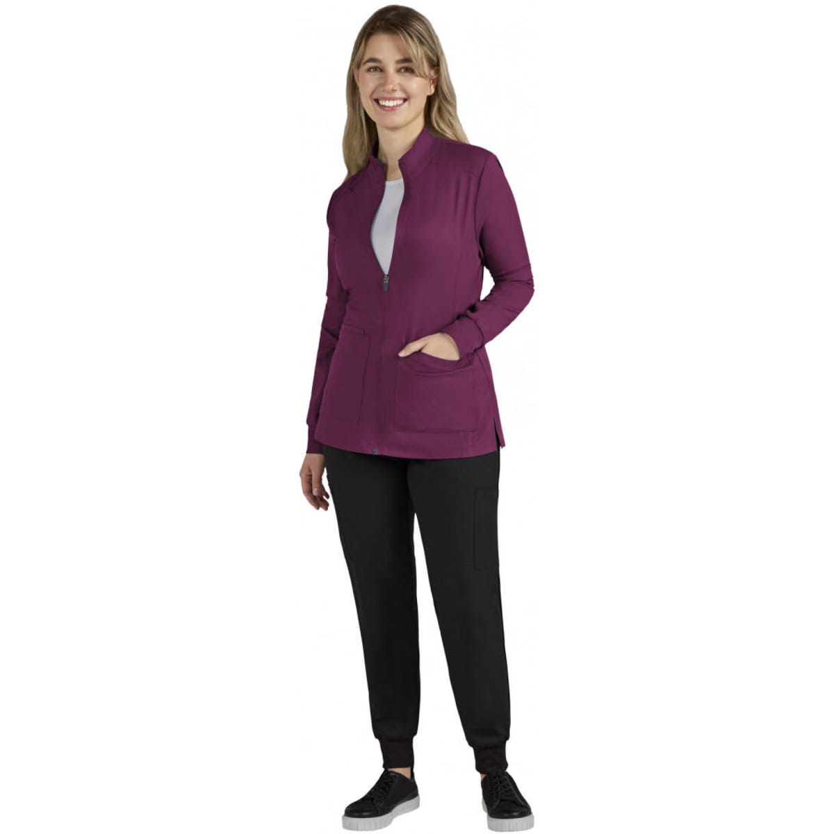 A women's jacket in a rich purple colour, featuring a zip front and pockets, paired with black trousers.
