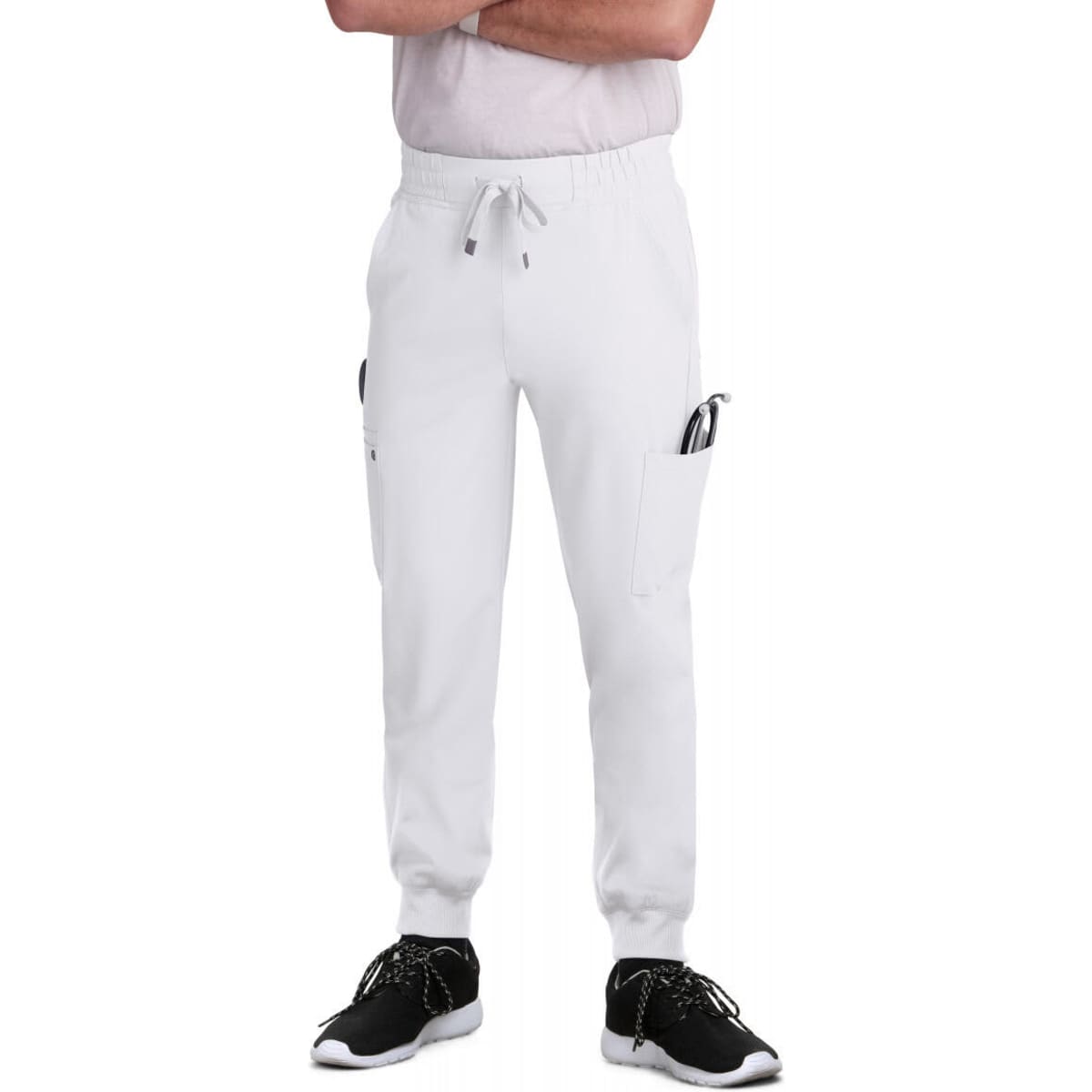 A pair of white jogger pants with pockets, styled with a casual top and black footwear.