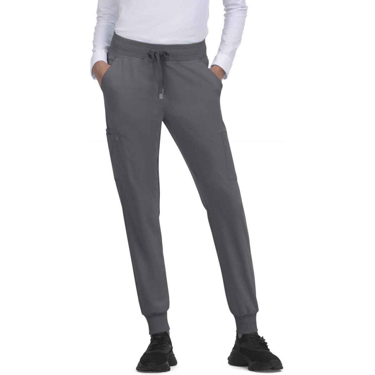 A pair of grey jogger pants with pockets, featuring an elastic waist and cuffs, and worn with black trainers.