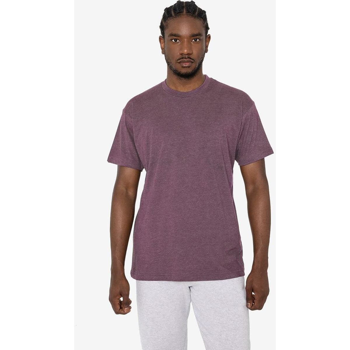 A short sleeve cotton-poly crew tee in a rich burgundy colour, worn by a model with braids. Features a branding logo.