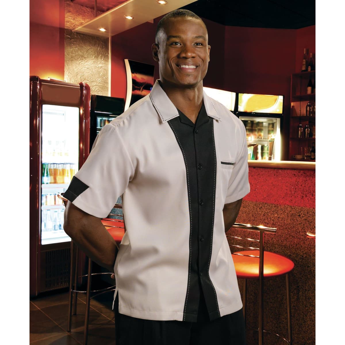A short-sleeved button-up shirt featuring a cream and black colour scheme, with a subtle logo.
