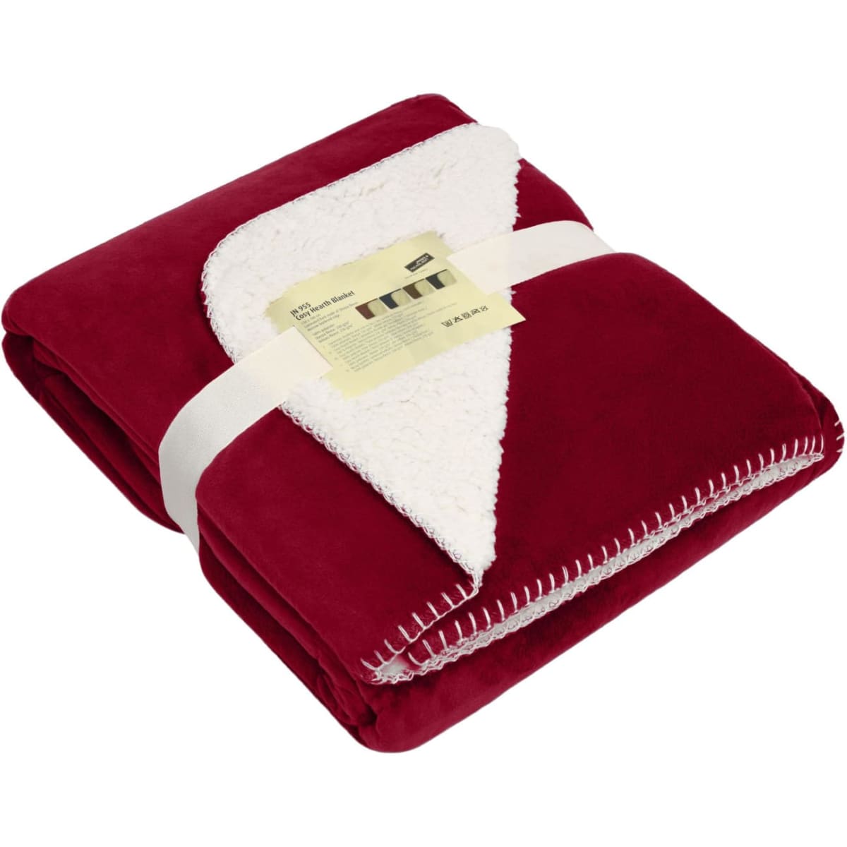 A red and cream blanket is neatly folded and secured with a ribbon, featuring a stitched edge.
