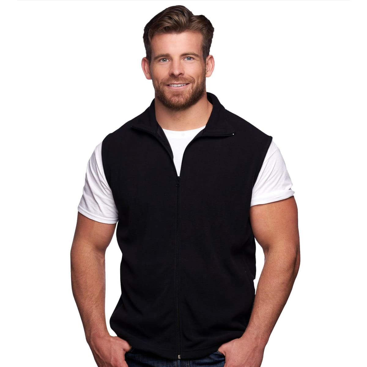 A man wearing a black full zip micro fleece vest over a white t-shirt, smiling at the camera. The vest has a logo.