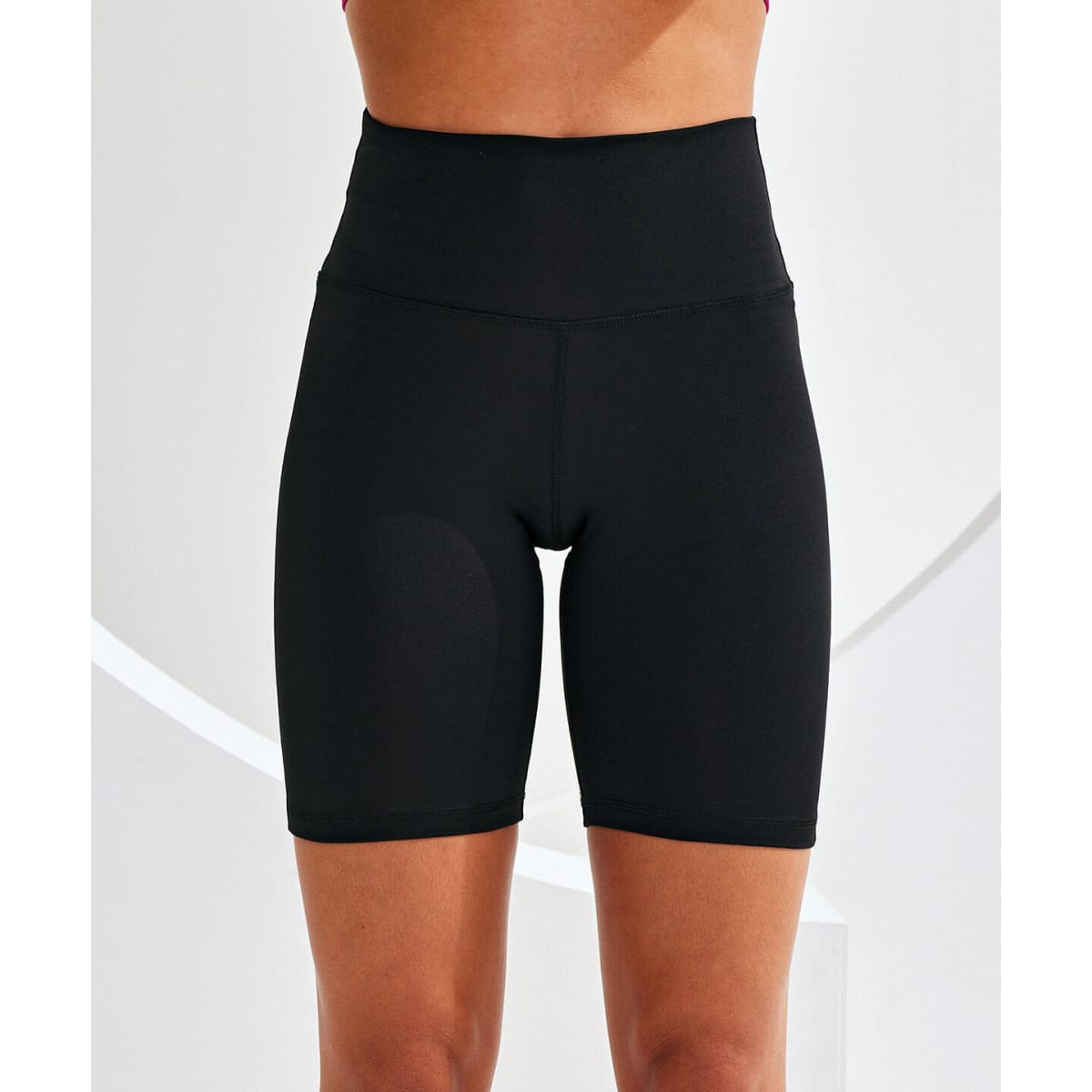 Black legging shorts with a high waist displayed on a model against a light background. Features a simple design.