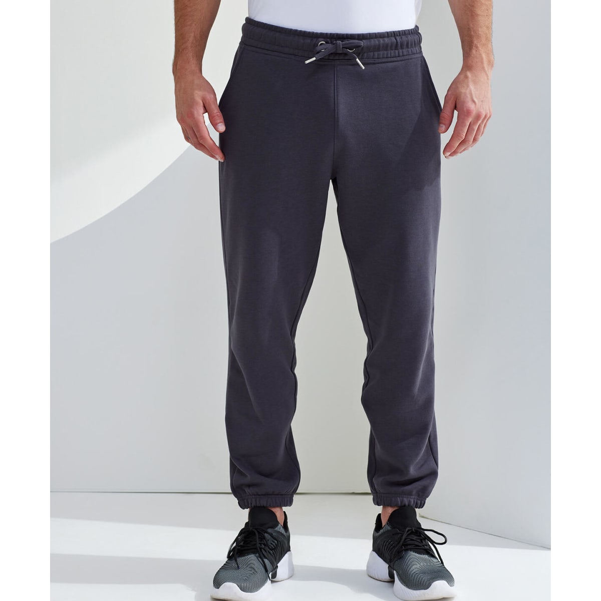 Classic joggers in dark grey with an elastic waistband and cuffs, featuring a drawstring detail.