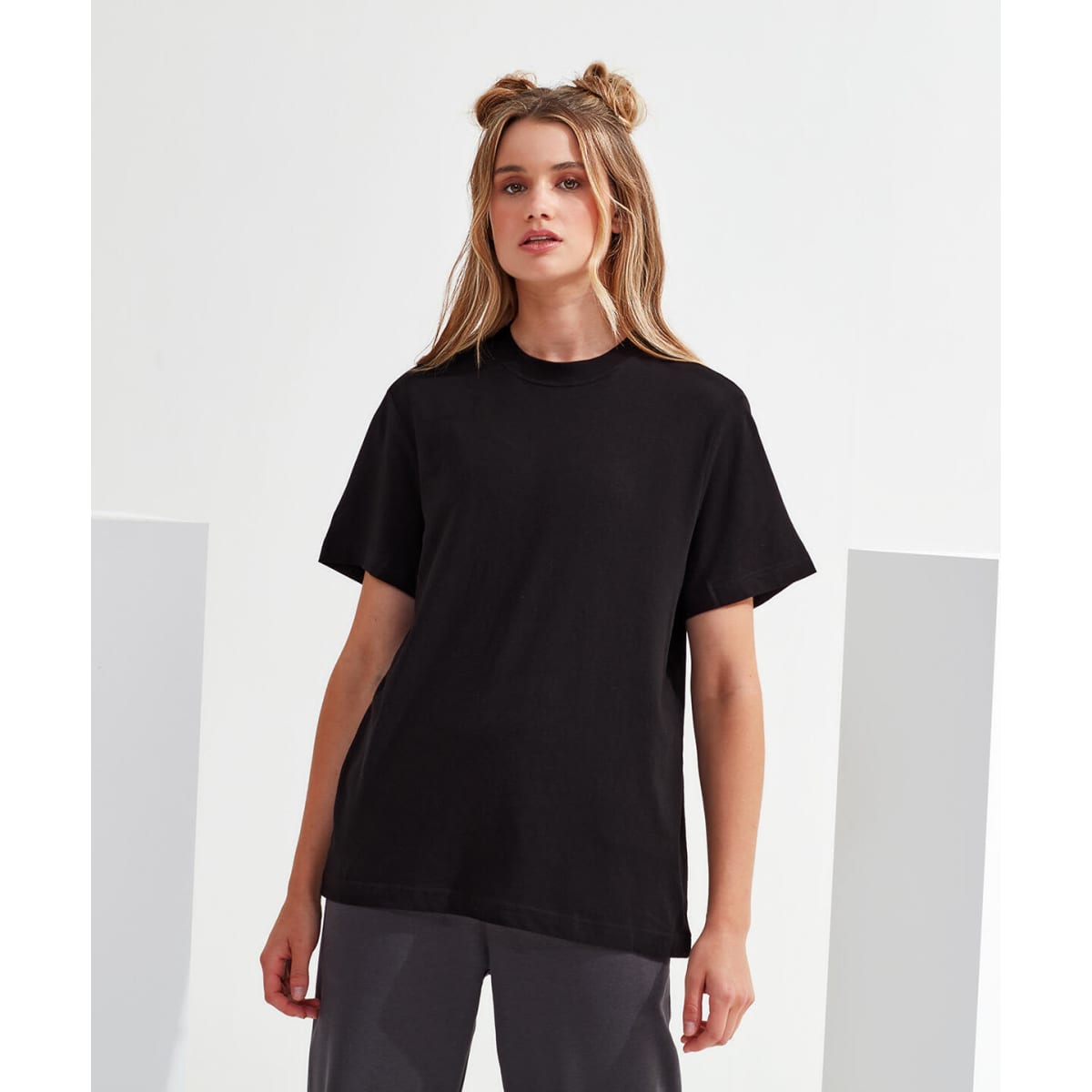 A black oversized t-shirt with a boxy fit and short sleeves, featuring a branding logo.