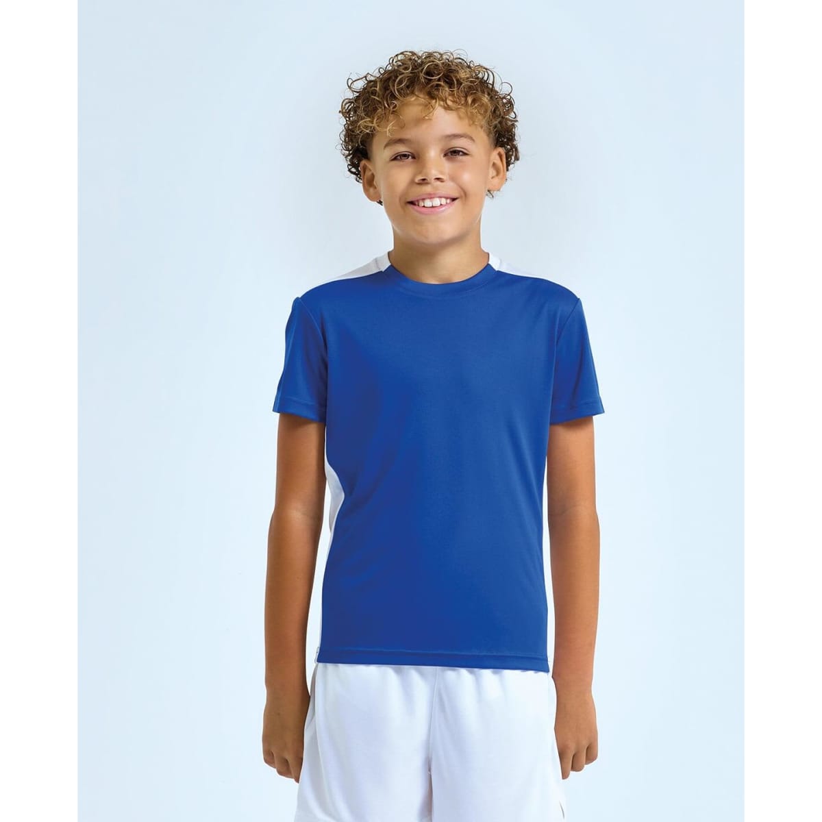 A children's performance t-shirt in blue with contrast white panels and a logo on the sleeve.