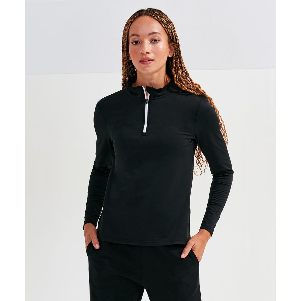 A black long sleeve brushed back 1/4 zip top, featuring a contrasting white zip and a fitted design.