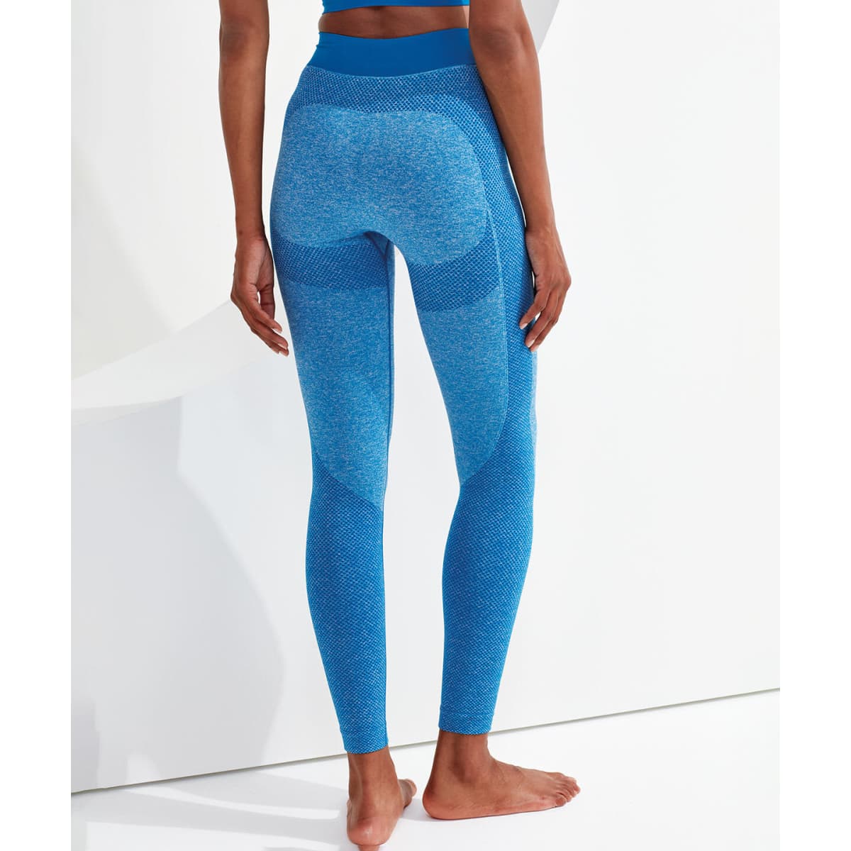A pair of blue seamless 3D fit sport sculpt leggings with a high waistband, seen from the back.
