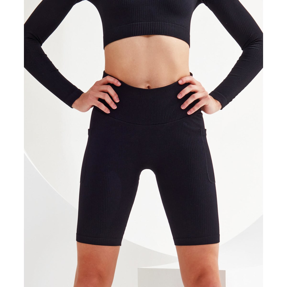 Ribbed seamless 3D fit cycle shorts in black, featuring a high waistband and side pockets, displayed on a model.