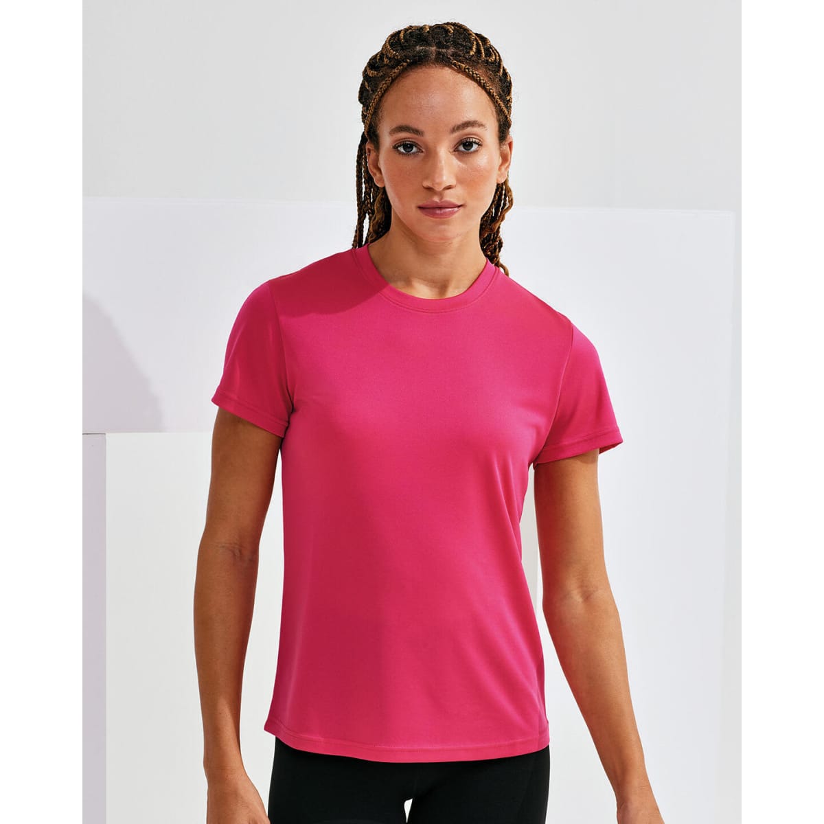 A pink, recycled textured t-shirt with short sleeves, featuring a logo on the chest.