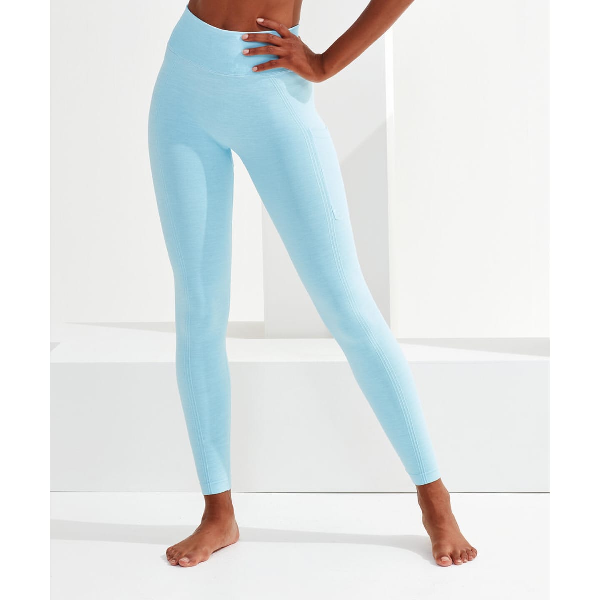 Light blue seamless leggings with a fitted design, featuring a side pocket and a subtle logo.