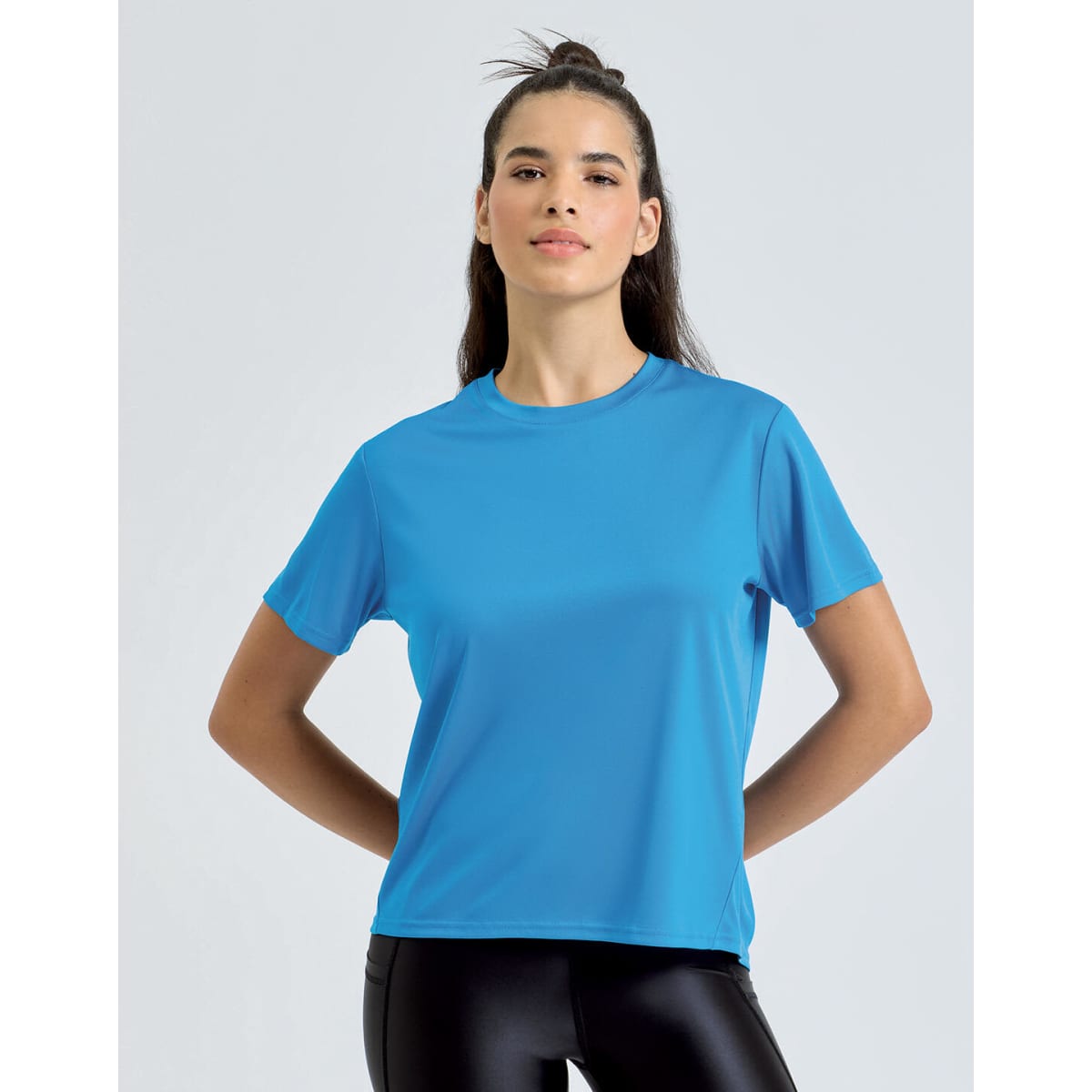 A blue athletic t-shirt is displayed on a model, featuring a relaxed fit and a simple design.