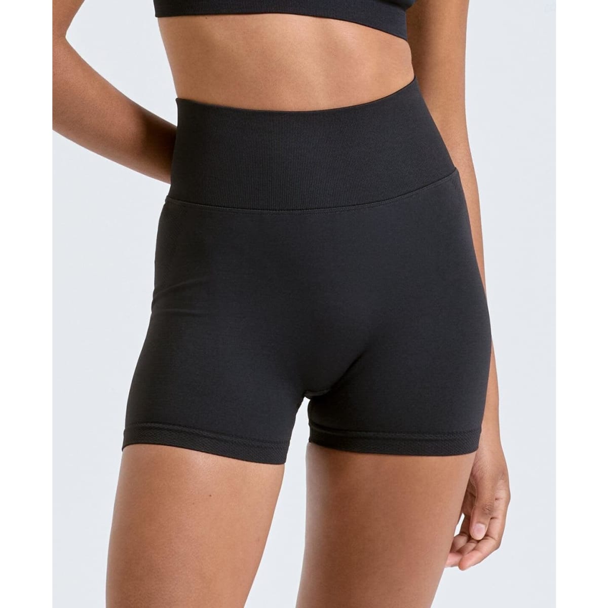 Black recycled scrunch shorts with a high waistband and a fitted design, displayed against a light grey background.
