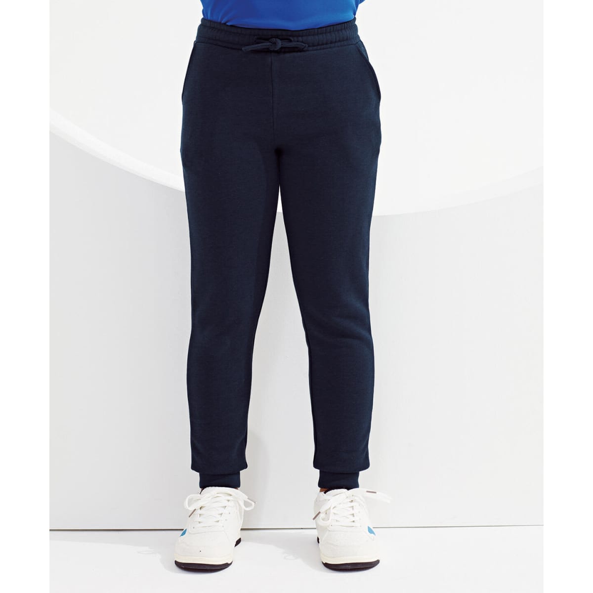 Navy blue kids' joggers with a drawstring waist and ribbed cuffs, displayed against a minimalist background.