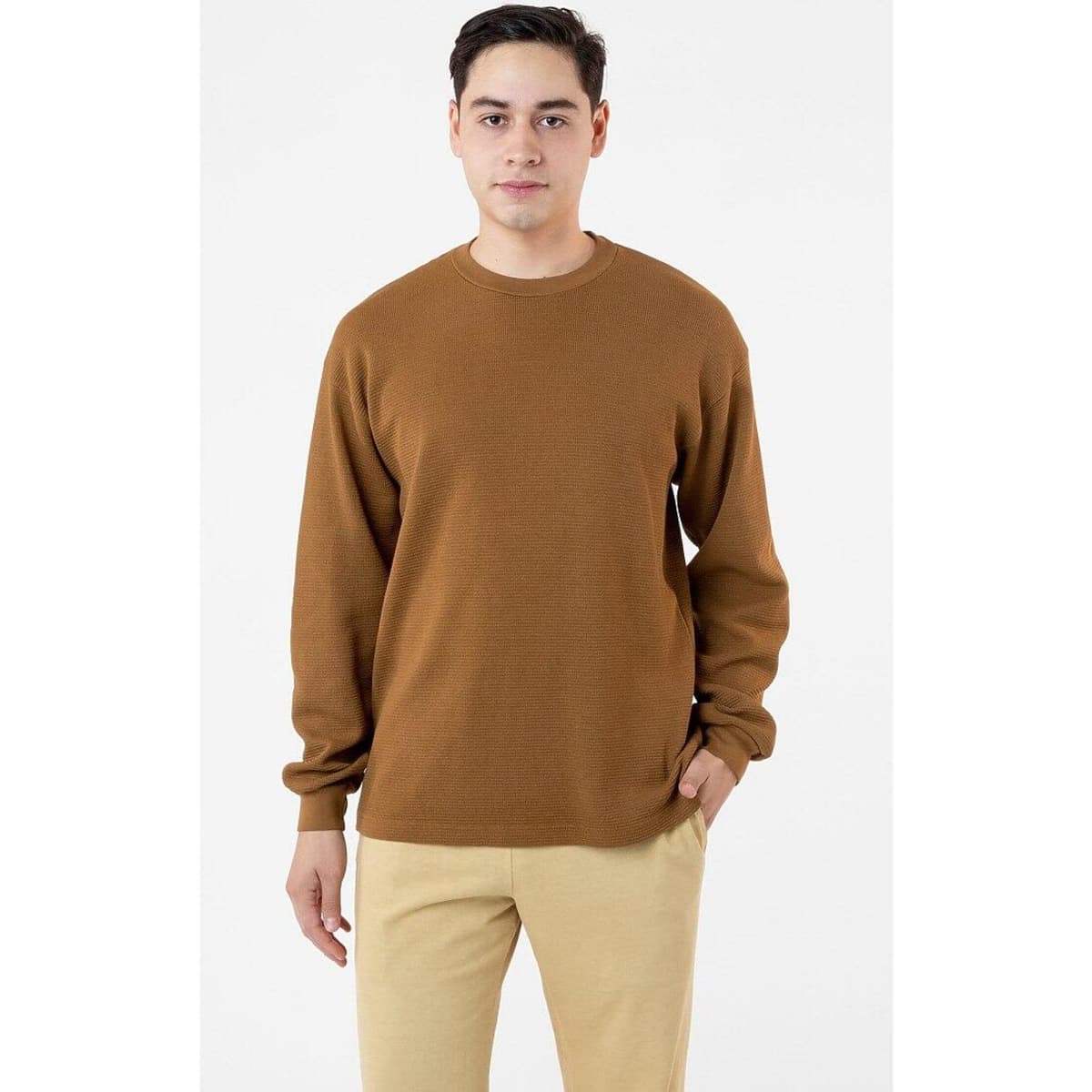 A brown heavy thermal crewneck sweater worn by a model, featuring a relaxed fit and long sleeves.