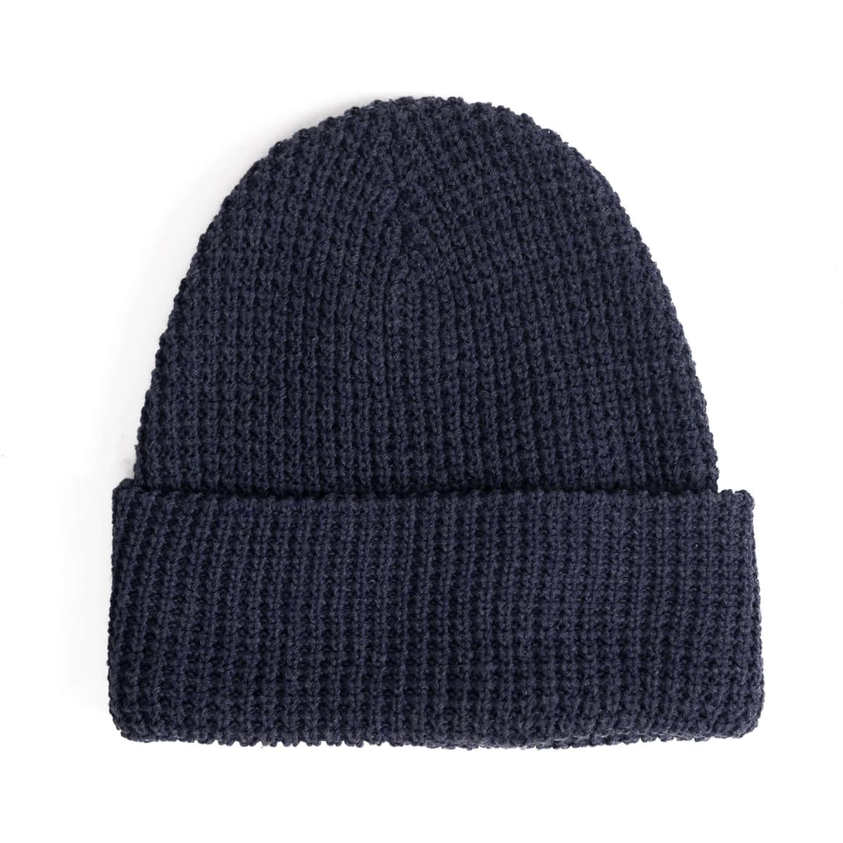A navy waffle knit beanie with a rolled cuff and a logo.