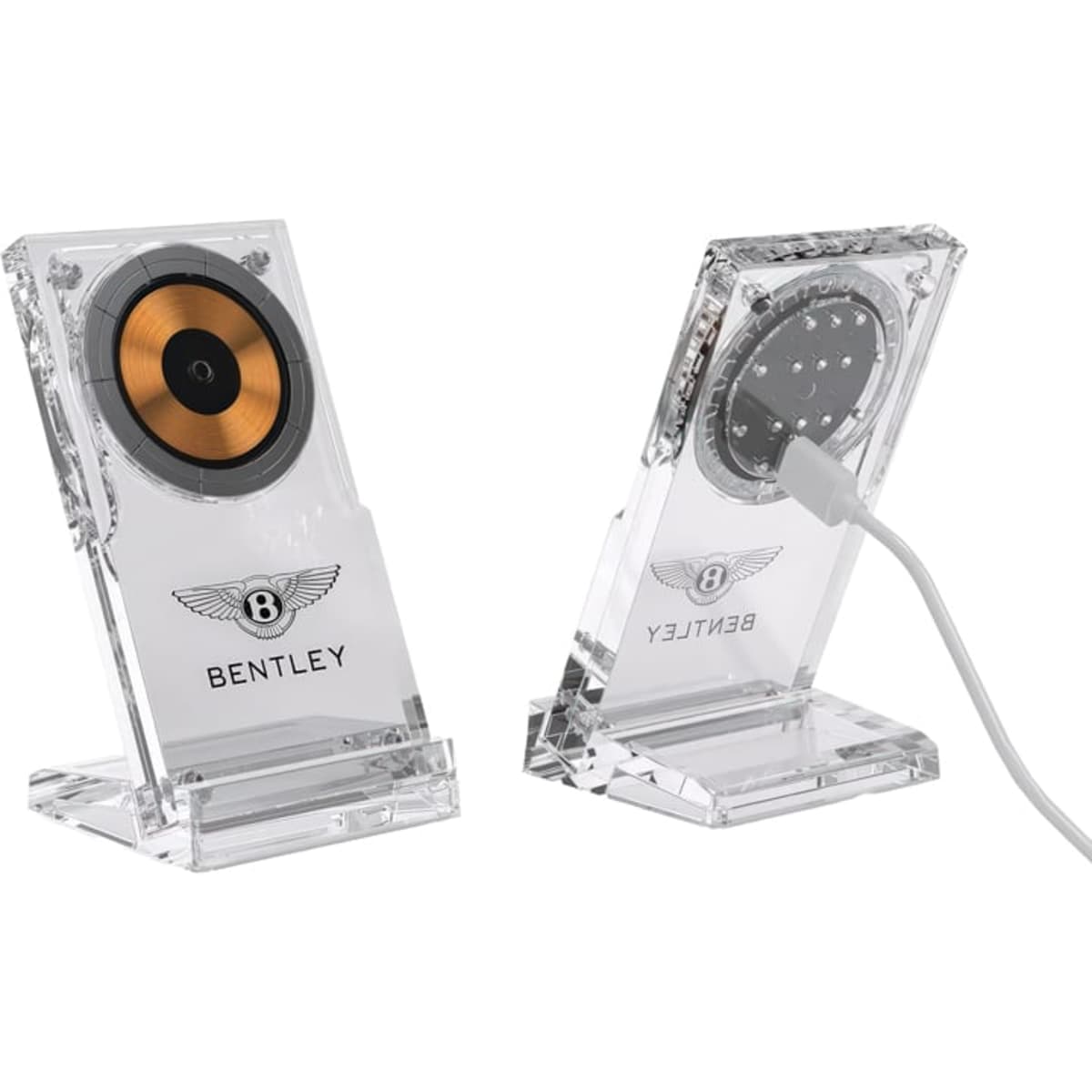 A clear acrylic magnetic wireless charging stand with a gold and black circular charging pad. It features a logo.