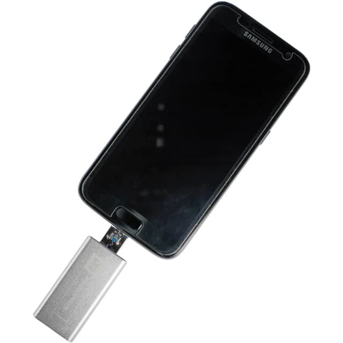 A silver Banion OTG USB 3.0 flash drive connected to a black smartphone. The device has a logo on it.
