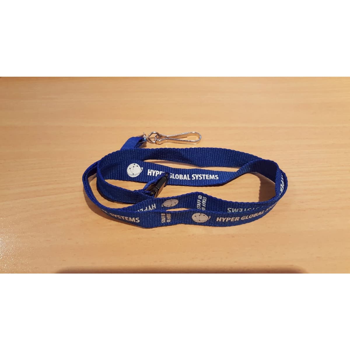 A blue lanyard with a clip and printed branding, suitable for exhibitions and events.
