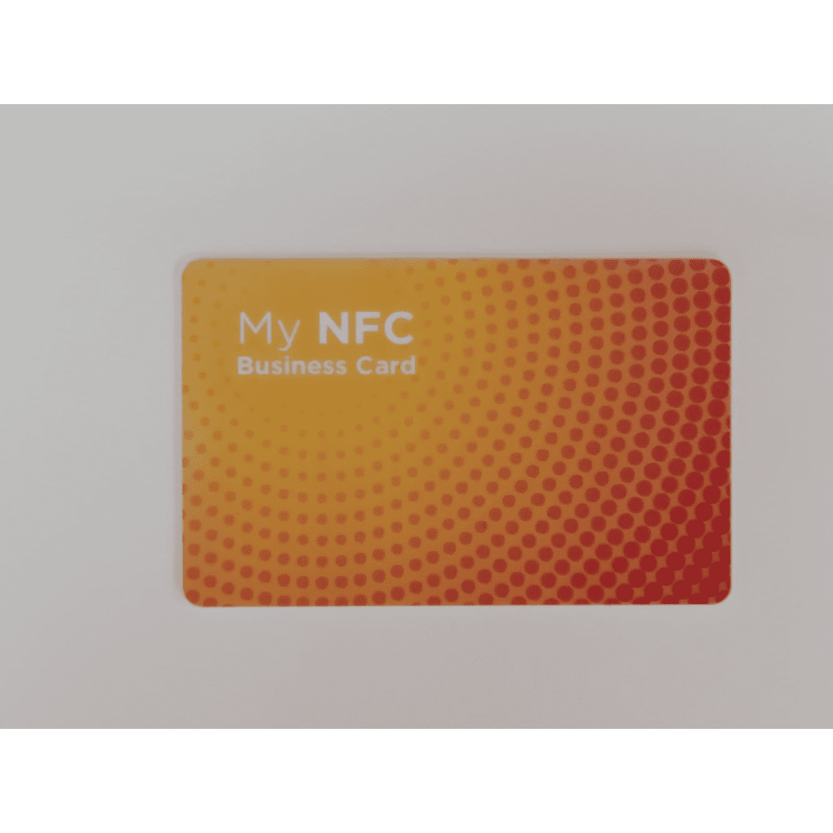 A rectangular business card in orange gradient with a dotted pattern and a logo.