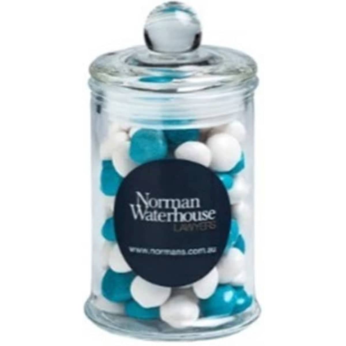 A clear apothecary jar filled with white and blue chewy fruit sweets, topped with a dome lid.