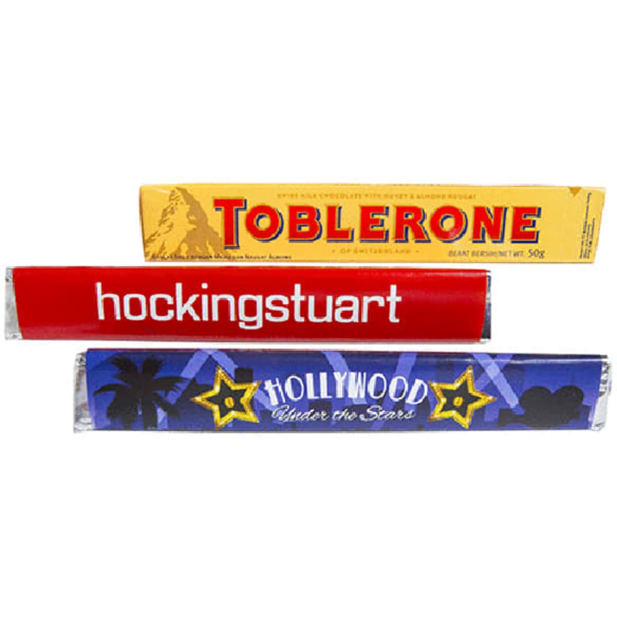 A Toblerone chocolate bar with a yellow sleeve, featuring red and blue wrapped items behind it.