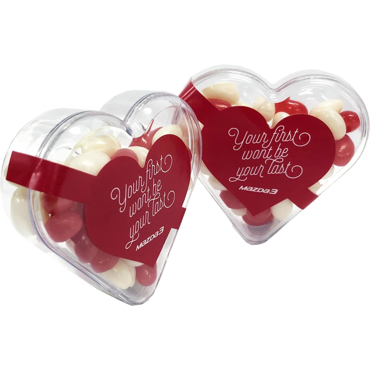 Acrylic heart-shaped container filled with red and white mini jelly beans. It features a logo on the packaging.