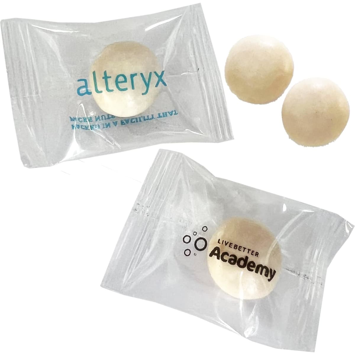 A pack of large, white chewy mints with two individual mints visible inside a clear wrapper featuring logos.
