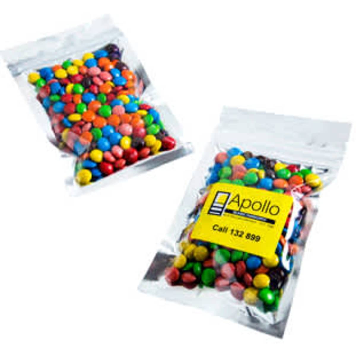 Silver zip lock bags containing colourful M&Ms, with one bag clearly visible and a logo present.