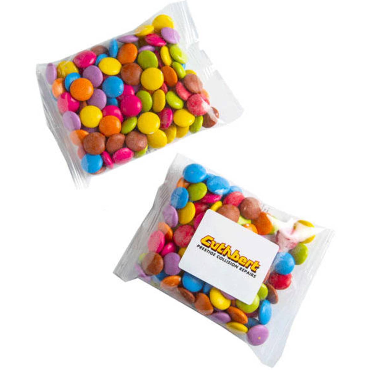 A clear bag contains colourful chocolate-coated candy pieces in various shades of pink, blue, yellow, green, and orange.
